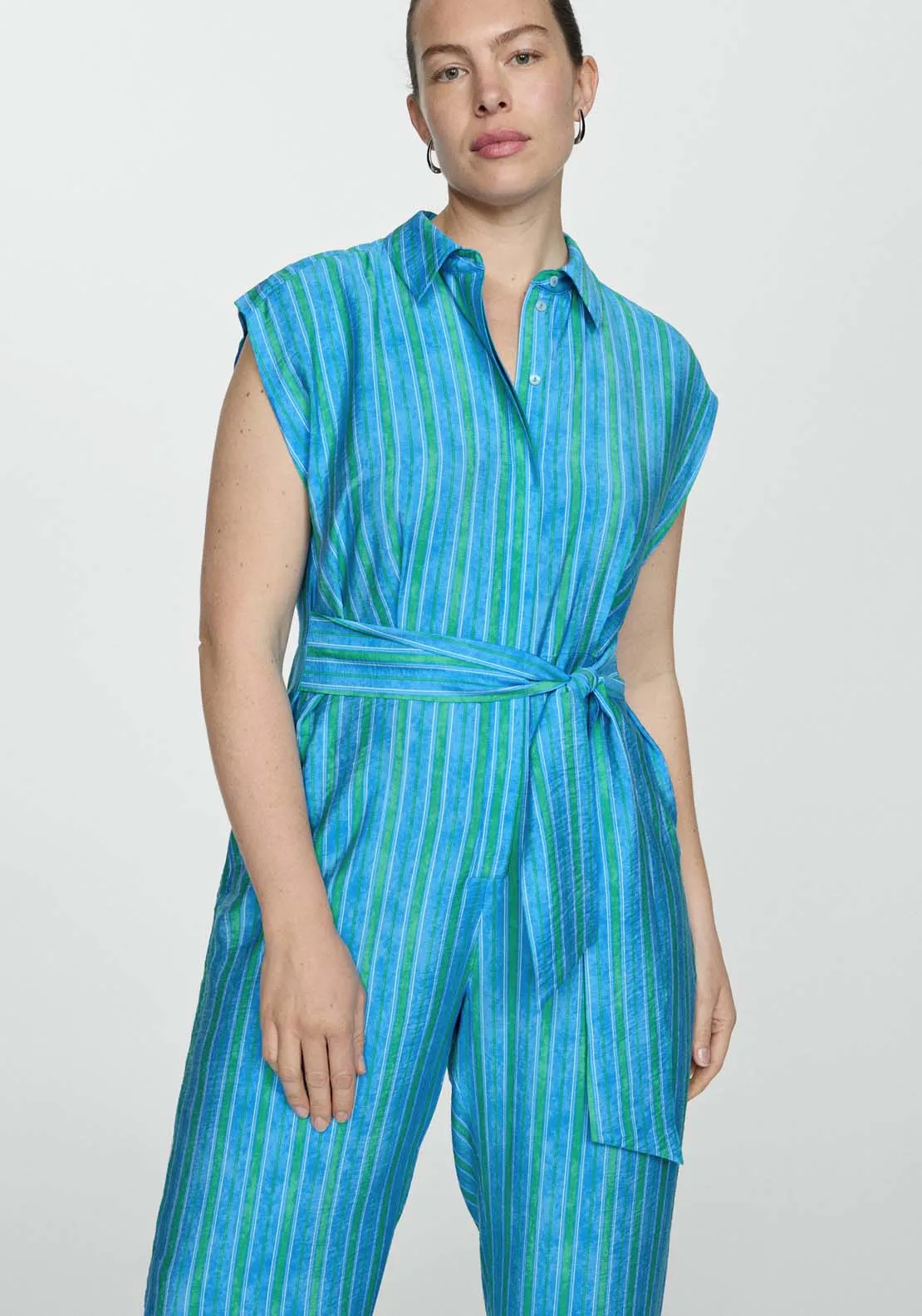 Shirt jumpsuit featuring a charming bow.