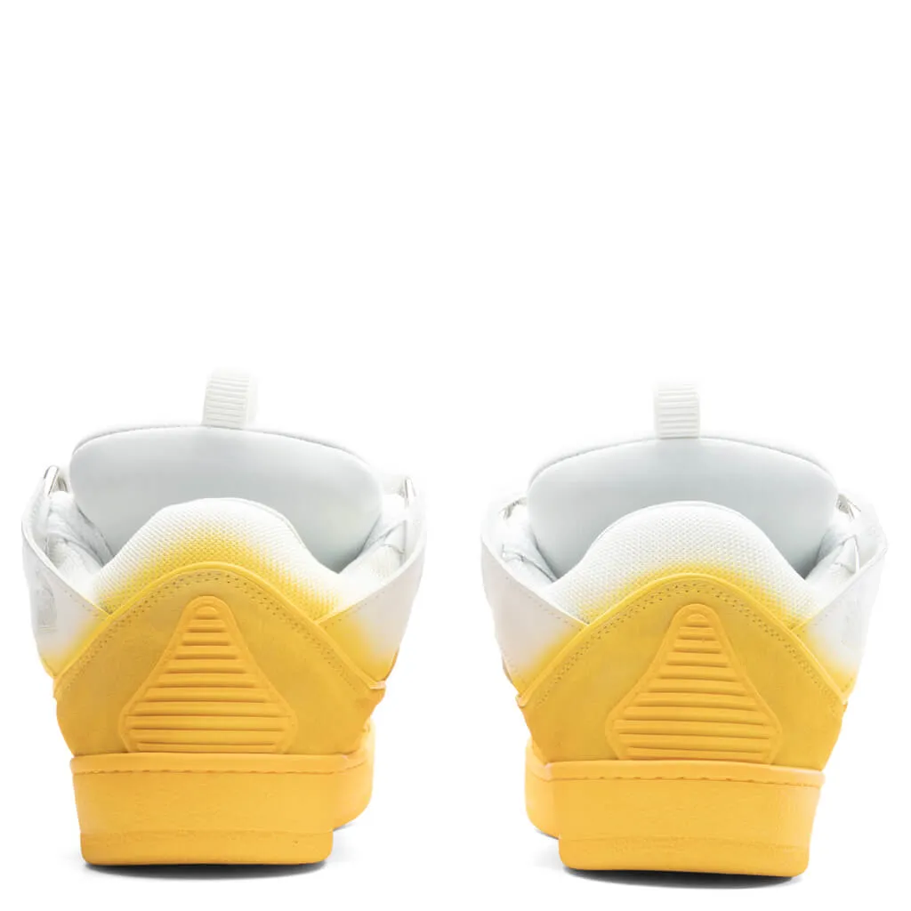 Yellow and white curb sneakers